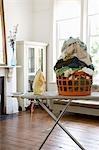 Laundry basket on ironing board