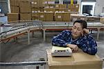 Woman asleep in distribution warehouse