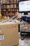 Man scanning bar code in distribution warehouse