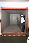 Man standing inside empty container