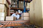 Man stacking boxes in distribution warehouse