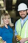 Man and woman working in newspaper factory