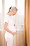 Pregnant woman by window