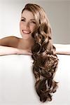 Woman with long brown curly hair