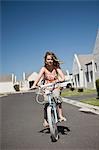 South Africa, Cape Town, girl riding bicycle on street