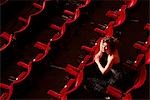 Woman sitting in theatre stalls, high angle view