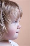 Side view, profile of blonde toddler with baby curls
