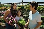 Mother, daughter and grandmother shopping in plant nursery