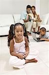 Girl sitting on living room floor Listening to Music on Portable CD Player, portrait