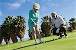 Senior couple playing golf