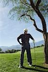 Senior man on golf course, (portrait)