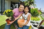 Mother and daughter gardening, (portrait)