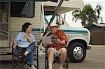 Couple relaxing outside motor home