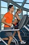 People Exercising on Treadmills in Health Club