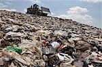 Digger working at landfill site