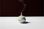 Single cupcake with blown out birthday candle
