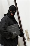 Burglar stealing laptop