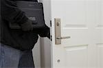 Burglar stealing laptop, mid section