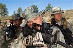 Soldiers aiming machine guns