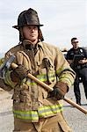 Firefighter with axe, police officer in background