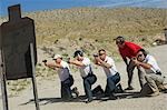 Men firing guns at shooting range