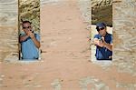 Two men aiming hand guns at firing range