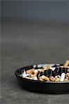 Full ashtray of cigarettes on table