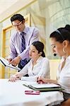 Three colleagues working in business meeting