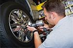 Mechanic Putting Tire on a Car