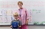 Teacher and Little Boy in Front of Class