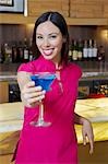 Woman Holding out a Blue Martini