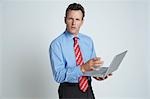 Studio shot of businessman with laptop