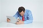 Studio shot of businessman using laptop