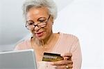 Senior Woman Using Laptop, Holding Credit Card