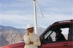 Mature woman by truck at wind farm