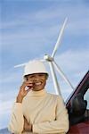 Mature woman by truck at wind farm