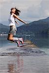 Woman Jumping in Shallow Water, Fuschlsee, Salzburg, Austria