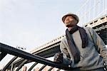 Man Standing in front of Bridge