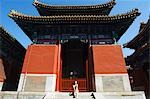 China,Beijing. A Chinese model sitting in front of the Confucius Temple and Imperial College built in 1306 by the grandson of Kublai Khan and administered the official Confucian examination system.