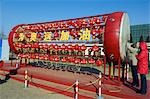 China,Beijing. Chinese New Year Spring Festival - A girl playing on a big drum decorated with lanterns.