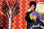 China,Beijing. Chinese New Year Spring Festival - two boys at a hawthorne sweet stand at Longtanhu Park Fair.