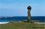 At Ahu Kote Riku,a single well preserved moai with white eyes and a red topknot,sits on top of one of the three ahus or platforms of the ceremonial centre of Tahai. Tahai is just a short walk from Easter Island's main settlement,Hanga Roa on the west coast of the island,backed by the Pacific Ocean