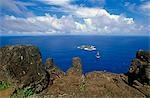 Chile,Easter Island. Petroglyphs carved into the basalt rock near to the Rano Kau crater and overlooking the Pacific. They depict human figures with birds' heads and curved beaks