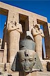 Headless statues of Ramses II line the courtyard at the entrance to the Ramesseum,Luxor,Egypt