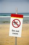 Do Not Swim sign warns holiday makers not to swim among the surfers on Fistral Beach,Newquay