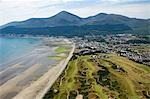 The Royal County Down golf course with the Slieve Donard Hotel,the small coastal town of Newcastle and the Mountains of Mourne behind