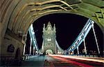 Night time traffic crosses Tower Bridge in central London. Built in 1894,the iconic bridge was designed to rise and allow ship to pass through.