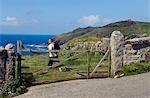 A walker sets off along the coastal path around Cape Cornwall on the north Cornish coast,England