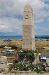 The war memorial in the Cornish village of Mousehole looks out over the harbour,Cornwall,England