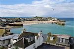 View over the rooftops of the hotels and houses surrounding the bay of the old Cornish fishing village of St Ives,Cornwall,England